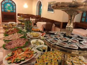 a long table with plates of food on it at Mokinba Hotels Montebianco in Milan +51 photos