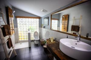 a bathroom with a sink and a toilet and a mirror at Sabay Beach in Kampot