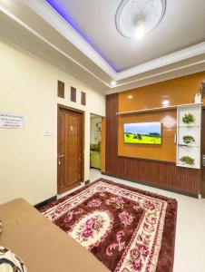 a living room with a large rug on the floor at Homestay Begonia Syari'ah in Dieng