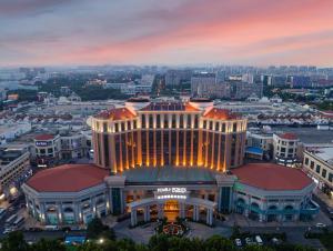 a view of the mgm grand building at dusk at Four Points by Sheraton Qingdao, Chengyang in Qingdao