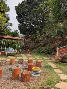 a group of stools sitting next to a fire pit at CharDara Agrotourism & FarmStay in Mahabaleshwar