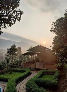 a house with a garden in front of it at CharDara Agrotourism & FarmStay in Mahabaleshwar