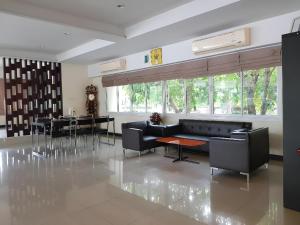 a living room with a couch and a table at Collection O VResotel in Nonthaburi +41 photos