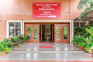 an entrance to a building with a red sign on it at Collection O VResotel in Nonthaburi
