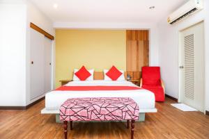 a bedroom with a bed and a red chair at King One Suvarnabhumi in Bangkok +32 photos