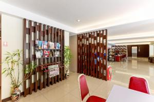 a room with a table and chairs in a building at Collection O VResotel in Nonthaburi