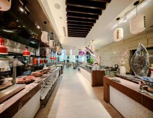 a restaurant with a long aisle with many counters at Four Points by Sheraton Qingdao, Chengyang in Qingdao