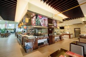 a restaurant with a buffet in the middle of a room at Four Points by Sheraton Qingdao, Chengyang in Qingdao