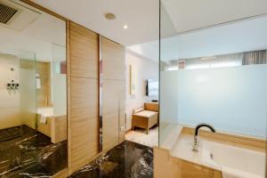 a bathroom with a shower and a sink at Four Points by Sheraton Qingdao, Chengyang in Qingdao