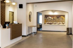 a lobby with a large painting on the wall at Wingate by Wyndham Owensboro in Owensboro +37 photos