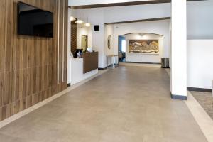 a hallway with a tile floor in a building at Wingate by Wyndham Owensboro in Owensboro