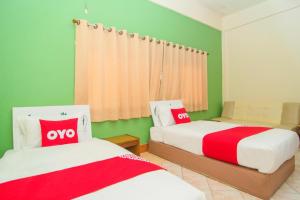 Postel nebo postele na pokoji v ubytování OYO 534 Phasuk Hotel