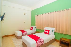Postel nebo postele na pokoji v ubytování OYO 534 Phasuk Hotel