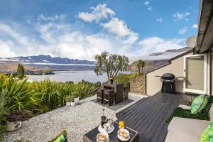 a patio with a view of a lake at Distinctive Alpine Meadows in Queenstown