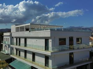 a large white building with a balcony on top of it at Maiorano Boutique Hotel in Manfredonia