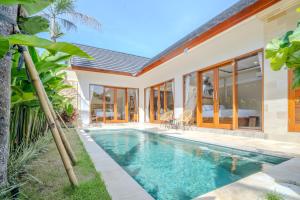 a swimming pool in the backyard of a house at Cozy 2BR Villa May II near Pererenan Beach in Cemagi