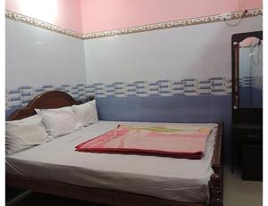 Voodi või voodid majutusasutuse Karthick Lodge, Rameswaram toas