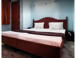 Voodi või voodid majutusasutuse Karthick Lodge, Rameswaram toas