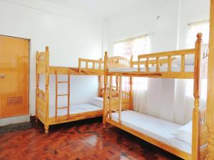 a room with three bunk beds in a room at RKC Guest House in Coron