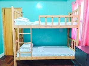 a bunk bed room with two bunk beds at RKC Guest House in Coron