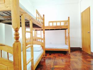 a room with two bunk beds and a staircase at RKC Guest House in Coron