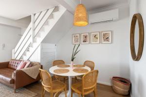 a dining room with a table and chairs at 'Seaside' at Henley in Henley Beach South