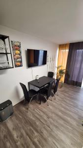 a dining room with a black table and chairs at Green Hills In Bad Bergzabern in Bad Bergzabern +25 photos
