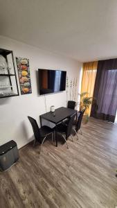 a dining room with a black table and chairs at Green Hills In Bad Bergzabern in Bad Bergzabern