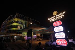 a group of signs in front of a building at night at Shree Durga Paradise in Kalyānpur