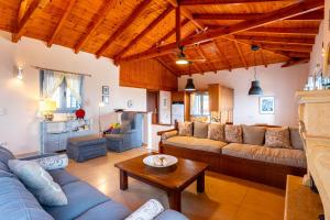 a large living room with couches and a table at Villa Eleni - Private Pool Retreat near Kardamili in Proástion
