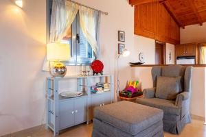 a living room with a chair and a table at Villa Eleni - Private Pool Retreat near Kardamili in Proástion +51 photos
