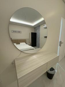 a mirror in a room with two beds in a room at Cozy Escape in Dammam