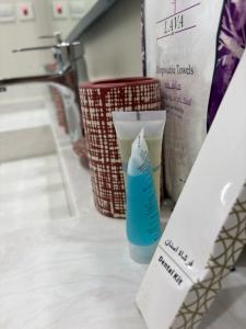 a bottle of bleach sitting on a counter next to two baskets at Cozy Escape in Dammam