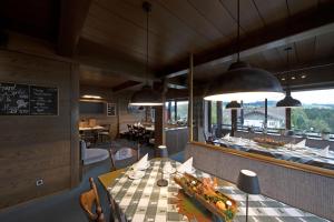 a dining room with a table and some lights at Pension Cafe Katharina in Stiefenhofen