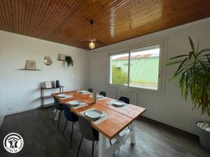 a dining room with a wooden table and chairs at Gîte rustique dans le Marais breton vendéen, proche plages - FR-1-426-575 in Sallertaine +15 photos