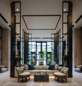 a living room with a large couch and chairs at Luxury Japanese Onsen Reserve - Bangkok in Bangkok