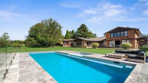 a swimming pool in front of a house at Warrington Park in Berrima +17 photos