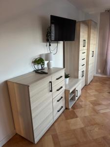 a room with a dresser with a tv on top at Oaza Spokoju in Augustów