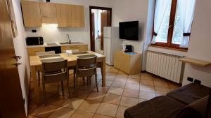 a kitchen with a table and chairs in a room at Residence Stella Alpina in Aprica