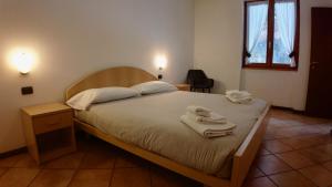 a bedroom with a bed with towels on it at Residence Stella Alpina in Aprica