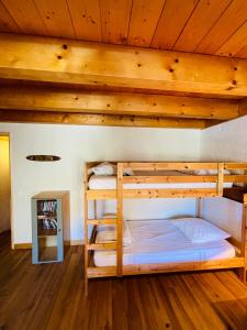 En eller flere senge i et værelse på Le Lodge des Aulps