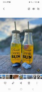 two bottles of drink drinks sun sitting next to each other at Haylees Hus 2 in Kellenhusen +8 photos