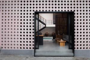 a building with a brick wall with a doorway at Atera Loft Canggu in Canggu +27 photos