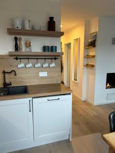 a kitchen with white cabinets and a counter top at Zum Schwedenblick in Zingst