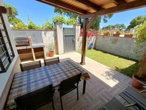 a patio with a table and chairs on a deck at Apartamento El Palmar, a 500 metros de la Playa in Vejer de la Frontera