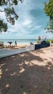 a fence on a beach with the ocean in the background at Santorini Gili Air North in Gili Air