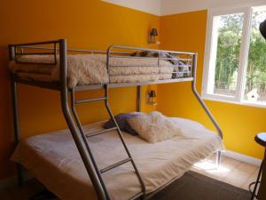FuveauにあるProche Aix en Pce, Villa Confortable avec piscine privéeの黄色い壁のドミトリールームの二段ベッド2台分です。 +8枚の写真
