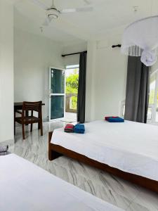 Ένα ή περισσότερα κρεβάτια σε δωμάτιο στο Mallika Resort