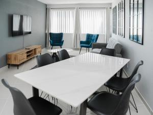 a meeting room with a white table and chairs at Romilly Beachfront 92 in Strand +3 photos