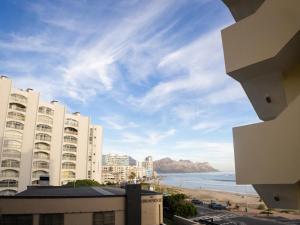 a view of the beach and buildings and the ocean at Romilly Beachfront 92 in Strand